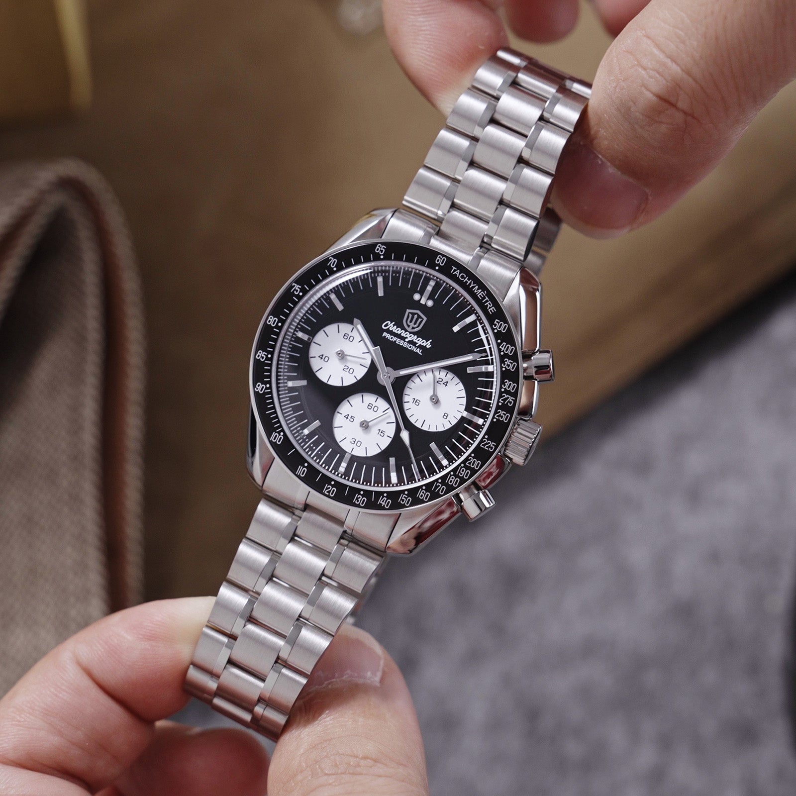 Hand-held Watchdives WD1863 Panda Racer with black dial, three light subdials and steel bracelet